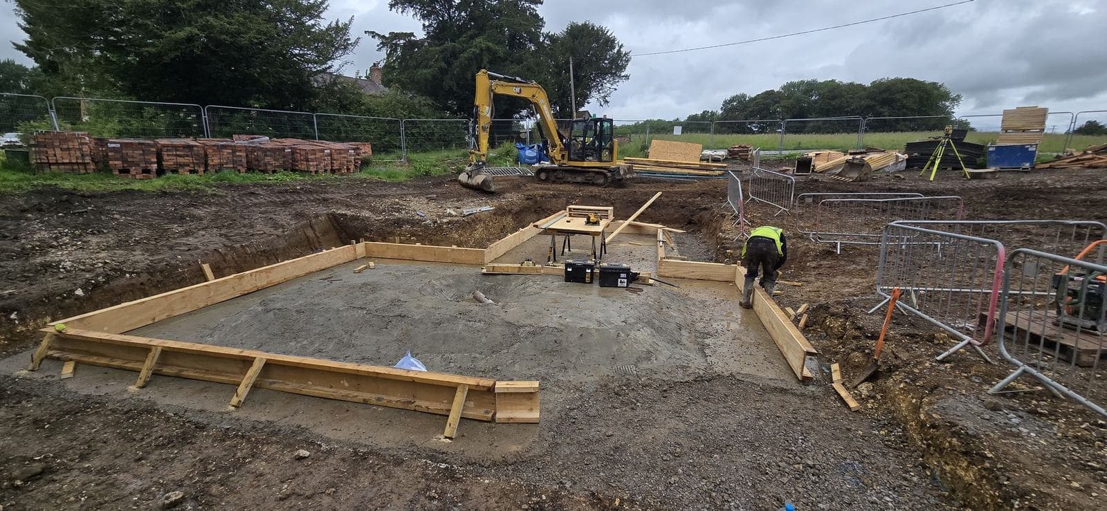 Foundation formwork in progress, with the slab area dug out and blinded