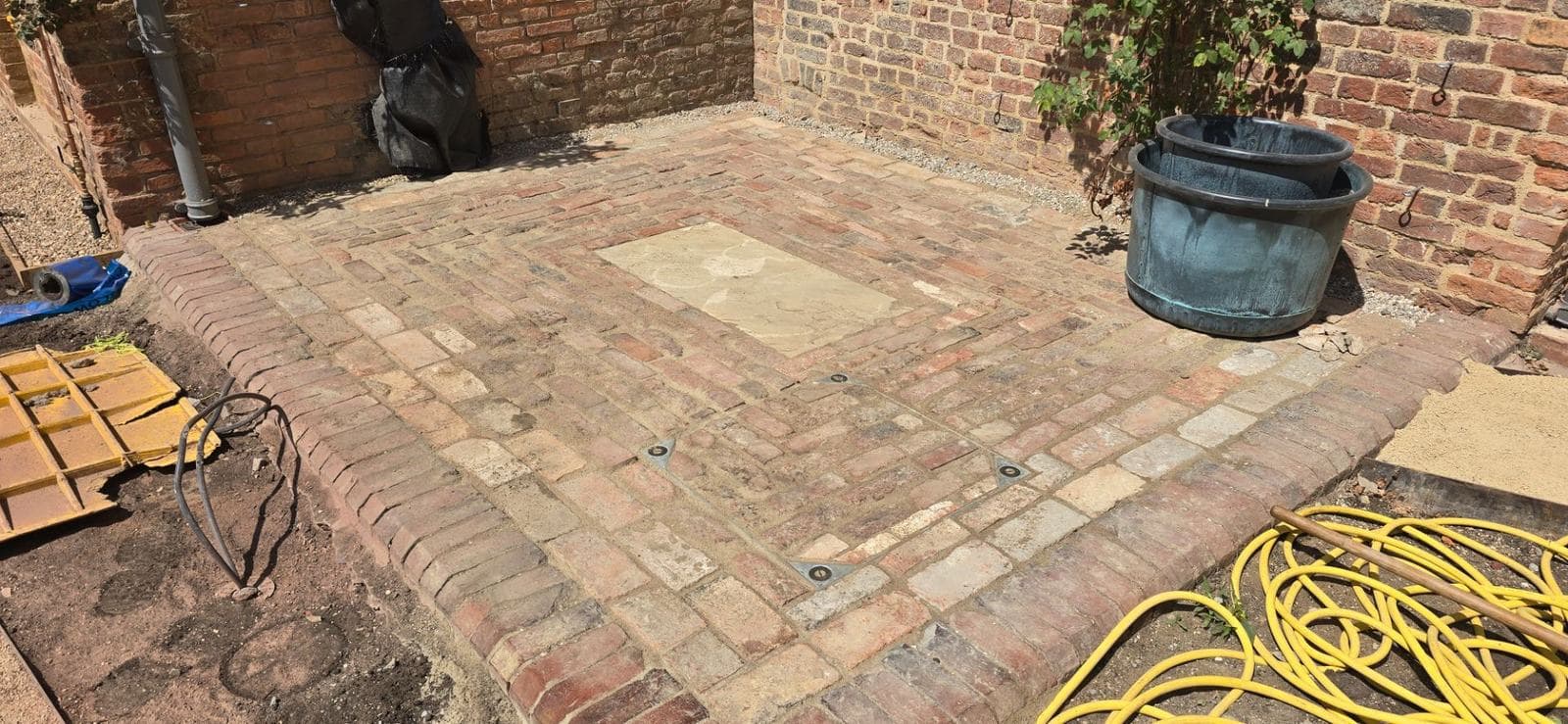 Completed reclaimed brick paving in the walled heritage courtyard
