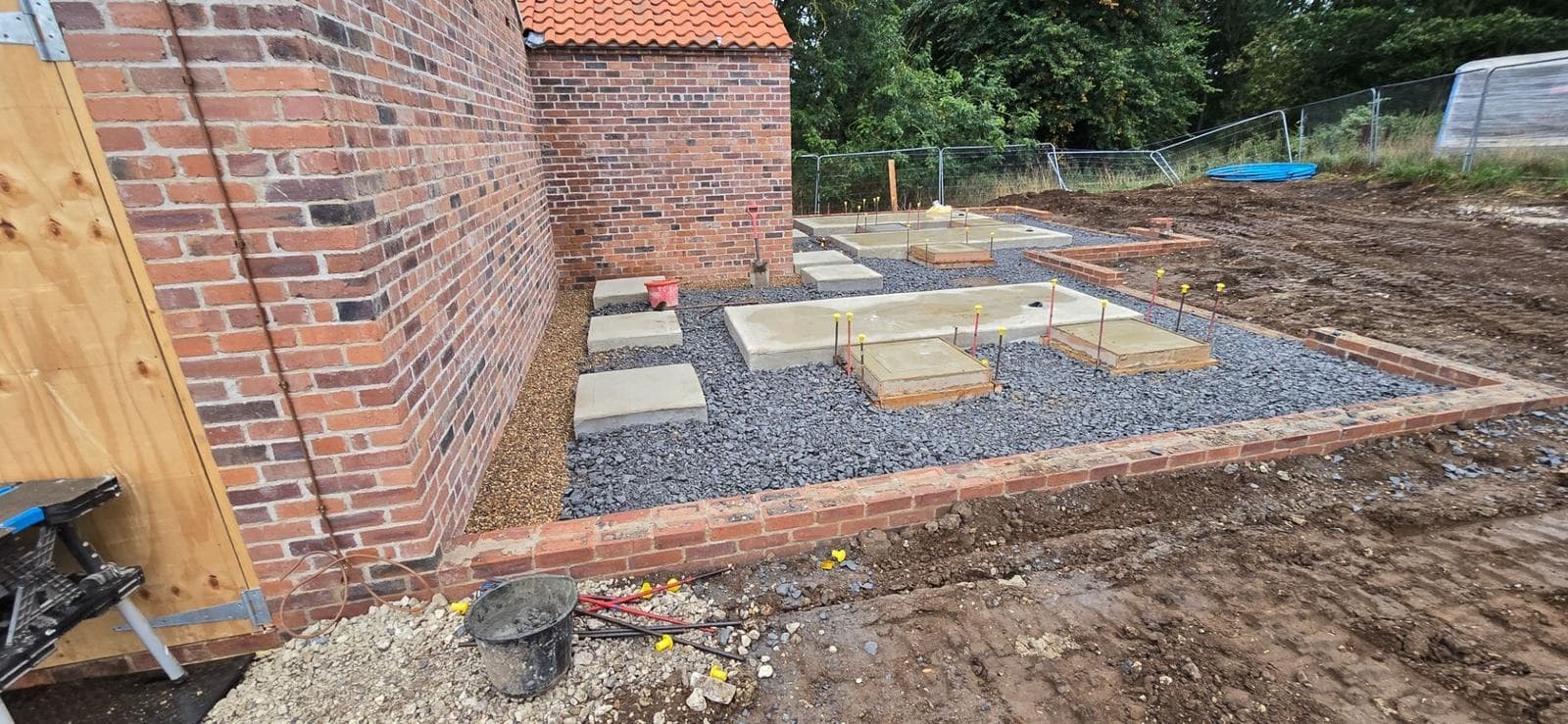 Pad foundation substructure alongside a heritage brick outbuilding