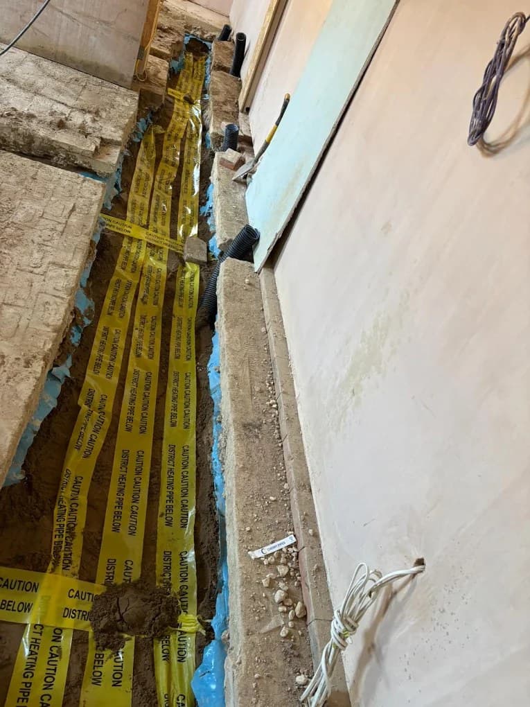 Yellow gas ducts bedded in sand in an open trench